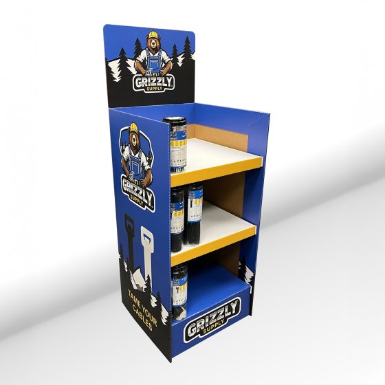 Custom corrugated point of purchase display with three shelves and full color Grizzly Supply branding, designed for retail floor placement.