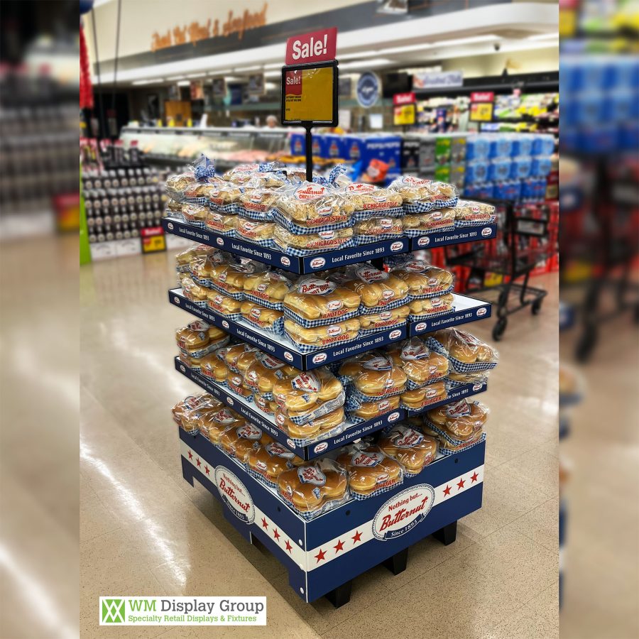 Butternut Bread branded 4-tier POD display at Jewel-Osco featuring hot dog, hamburger, and Chicago-style buns, with sign holder and blue star-and-checkerboard graphics